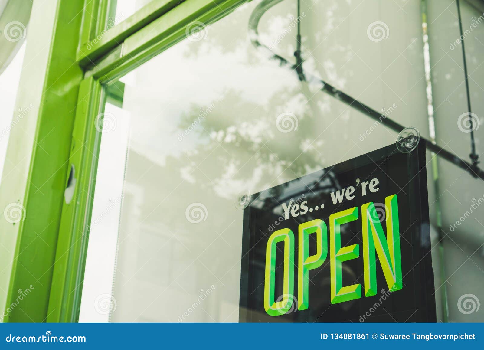 a business sign that says Ã¢â¬ËopenÃ¢â¬â¢ on cafe or restaurant hang on door at entrance.